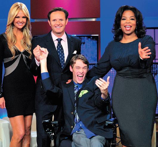 Oprah Winfrey names the winners of Your OWN show: Oprah's Search For The Next TV Star. And the winners are... Zach Anner (seated) and Kristina Kuzmic-Crocco (not featured). To the left of Zack is producer Mark Burnett and show host Nancy O'Dell 